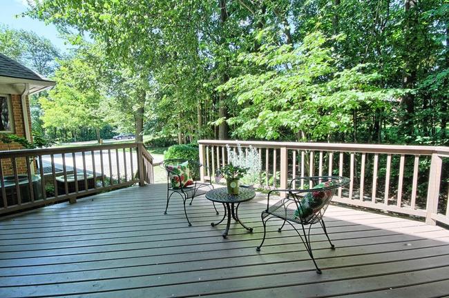 new wooden deck with patio chairs in Novi home