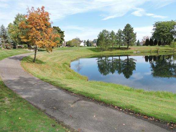 pond, walking trail, and landscape at Country Club Village