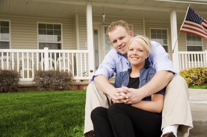 man and woman sitting outside their dream home in northville